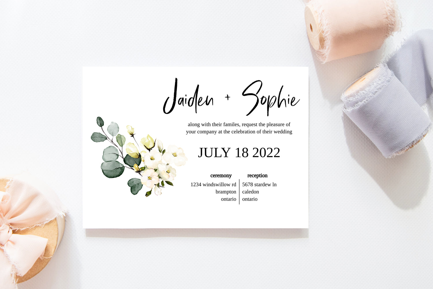 Printable floral wedding invitation template with white flowers and eucalyptus graphic. 