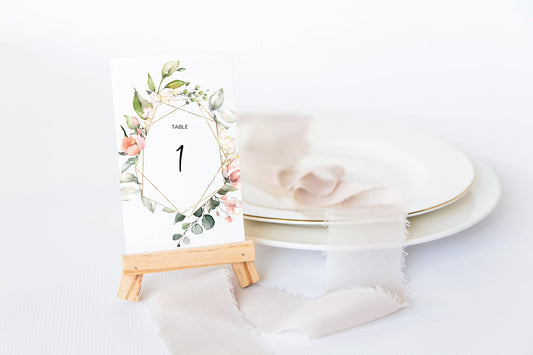 Table number template with a frame of pink flowers and leaves